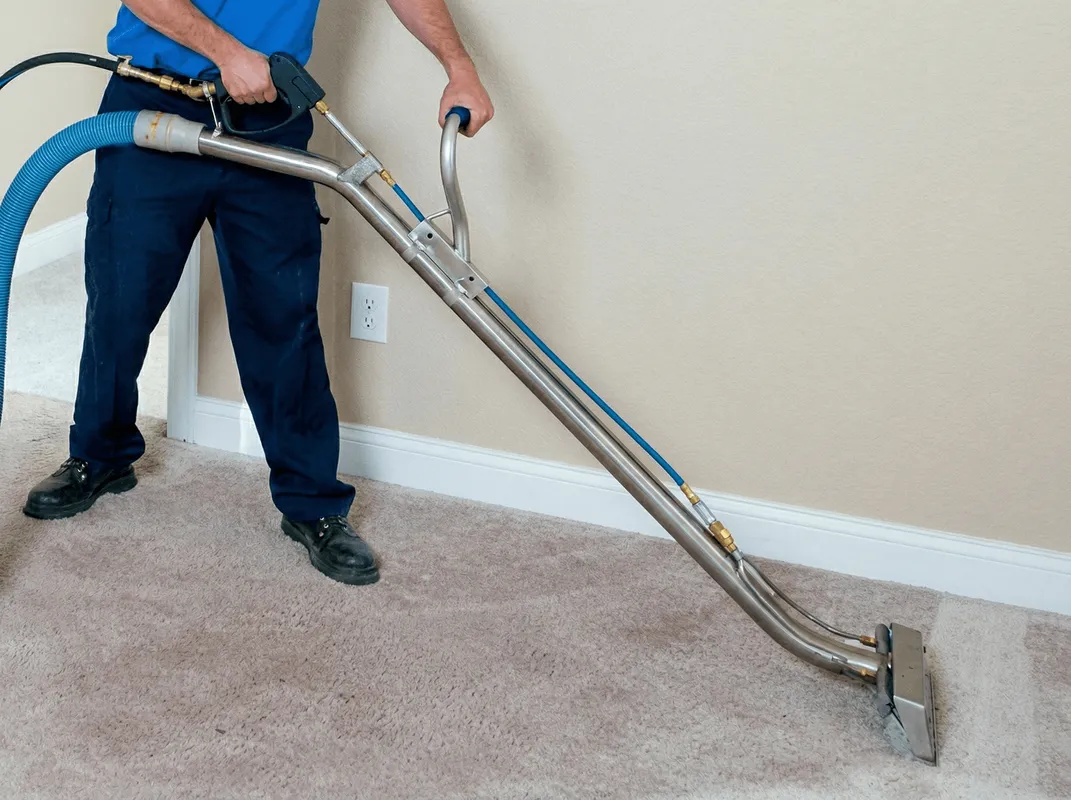 Professional operating a liquid removal machine on a carpeted floor in San Jose, CA